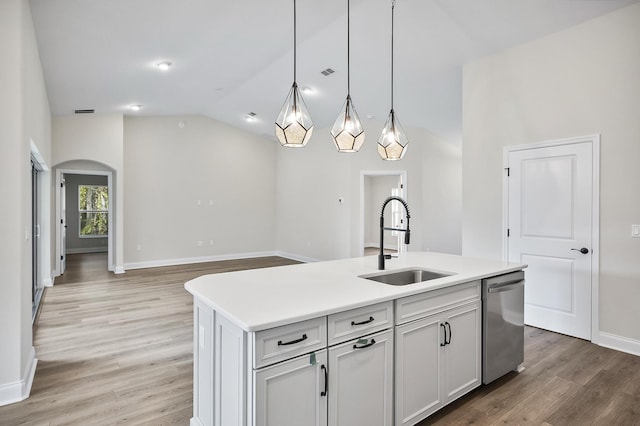 kitchen featuring hardwood / wood-style floors, a center island with sink, stainless steel dishwasher, and sink