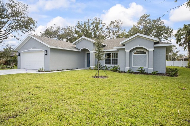 ranch-style house featuring a front lawn and a garage