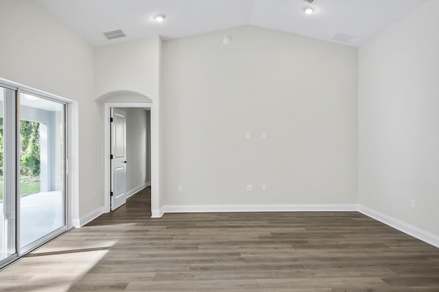 unfurnished room featuring lofted ceiling and dark wood-type flooring