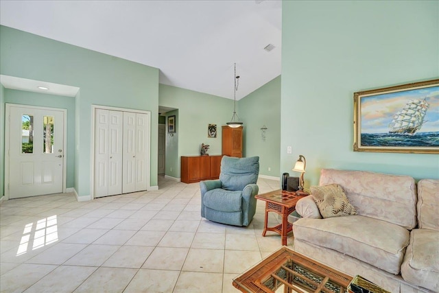 tiled living room with high vaulted ceiling