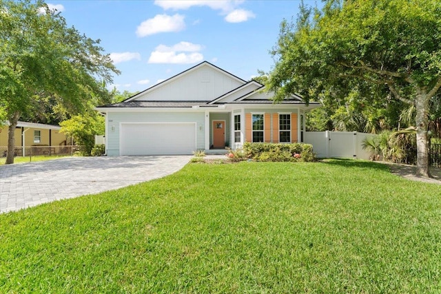 633 W Pope Rd, Saint Augustine, FL 32080 - view of front of home featuring driveway, an attached garage, a gate, and board and batten siding