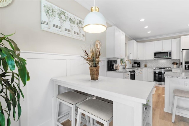 633 W Pope Rd, Saint Augustine, FL 32080 - kitchen featuring stainless steel appliances, decorative backsplash, white cabinetry, and recessed lighting
