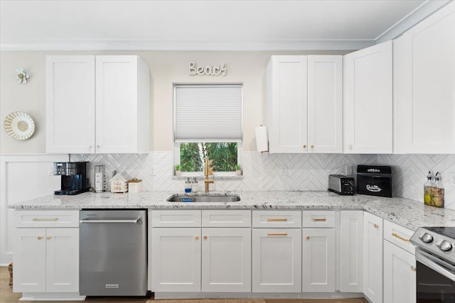 633 W Pope Rd, Saint Augustine, FL 32080 - kitchen featuring stainless steel appliances, white cabinetry, and backsplash