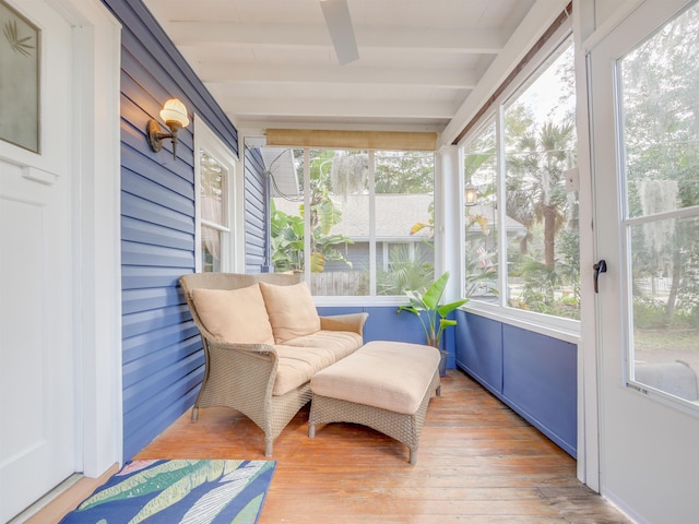 sunroom featuring beamed ceiling and a wealth of natural light