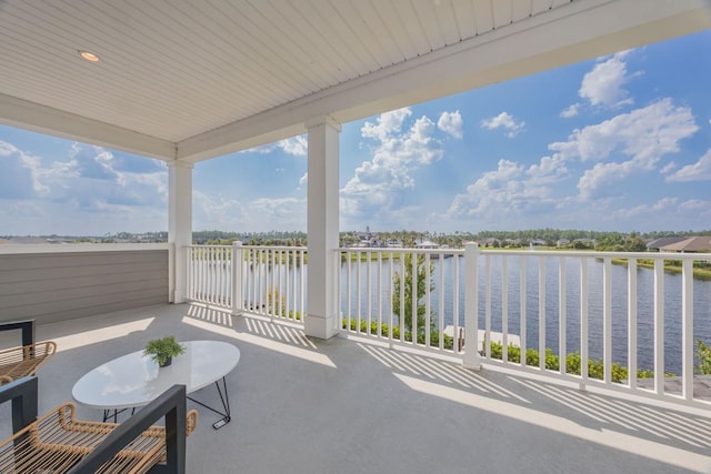 view of patio / terrace featuring a water view and a balcony