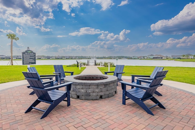 view of patio with a water view and a fire pit