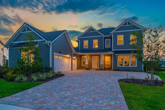 craftsman inspired home with a yard and a garage