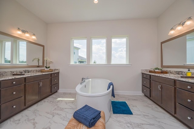 bathroom featuring vanity and a bath