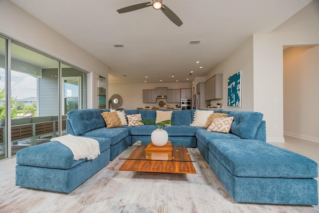 living room with ceiling fan and light hardwood / wood-style floors