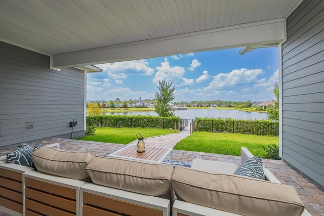 view of patio featuring outdoor lounge area and a water view