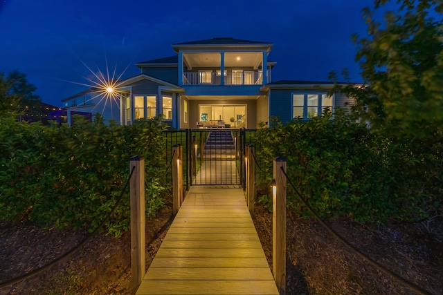 back house at twilight with a balcony