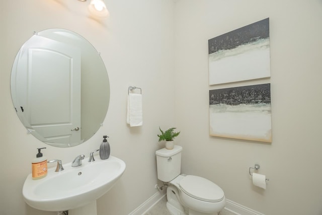 bathroom featuring toilet and sink