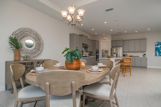 dining area featuring sink, light tile patterned floors, and a notable chandelier