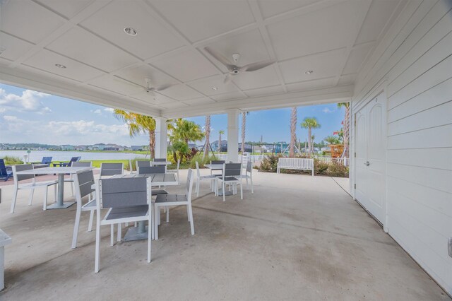 view of patio / terrace featuring ceiling fan and a water view