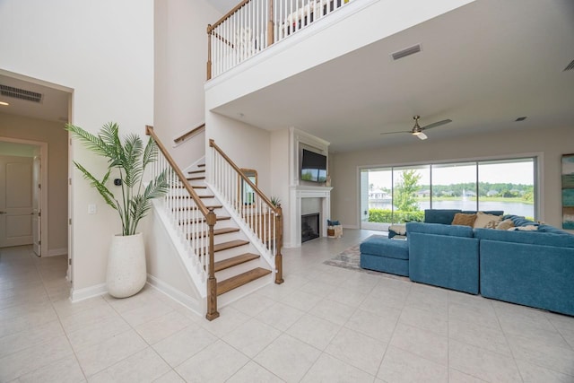 tiled living room featuring ceiling fan