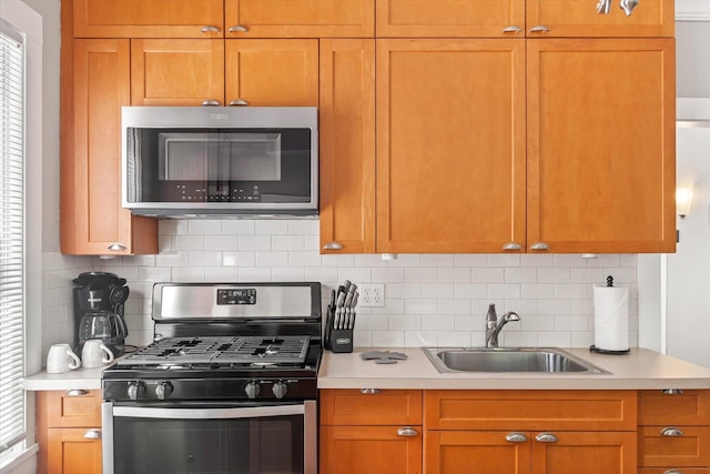 54 Grove Ave, Saint Augustine, FL 32084 - kitchen with appliances with stainless steel finishes, a sink, light countertops, and decorative backsplash