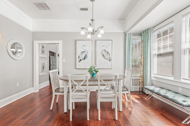 54 Grove Ave, Saint Augustine, FL 32084 - dining space featuring a chandelier, baseboards, and dark wood-type flooring