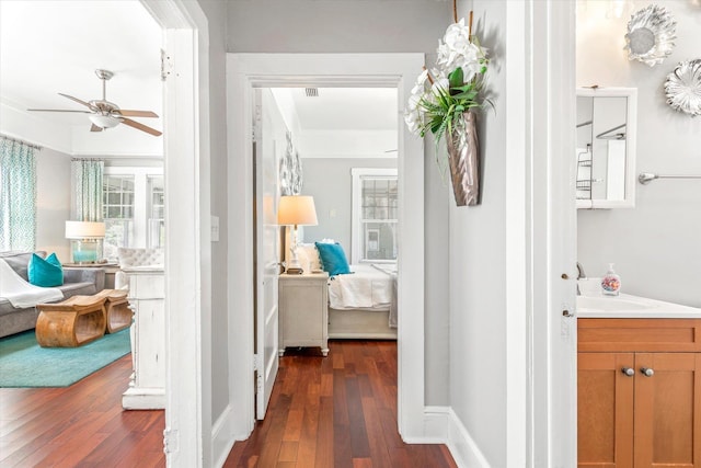54 Grove Ave, Saint Augustine, FL 32084 - hallway featuring dark wood-style floors, a sink, and baseboards
