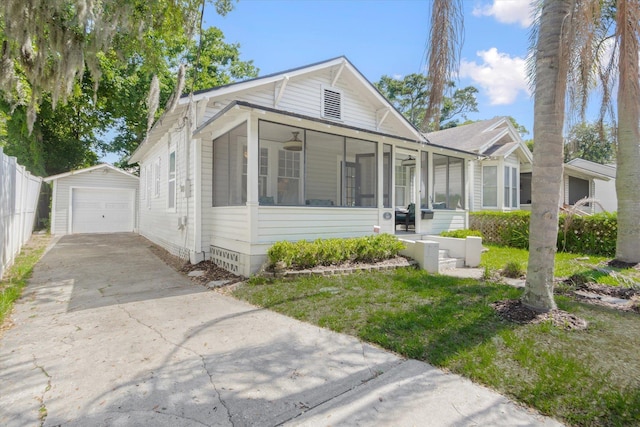 54 Grove Ave, Saint Augustine, FL 32084 - view of front of property with a sunroom, an outbuilding, a detached garage, and driveway
