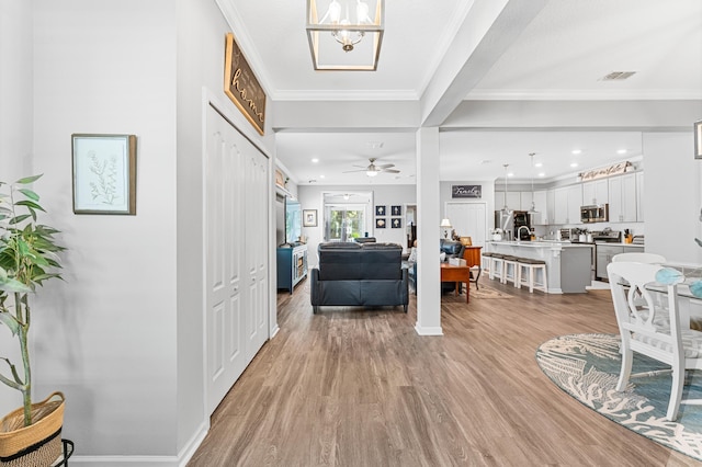 313 Aventurine Ave, Saint Augustine, FL 32086 - entrance foyer featuring light wood-style floors, recessed lighting, ceiling fan, crown molding, and a chandelier