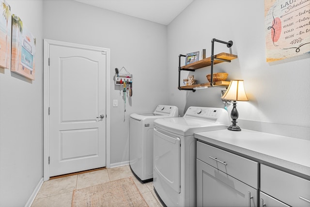 313 Aventurine Ave, Saint Augustine, FL 32086 - laundry area with cabinet space, washing machine and clothes dryer, and light tile patterned flooring