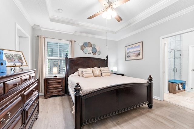 313 Aventurine Ave, Saint Augustine, FL 32086 - bedroom featuring a tray ceiling, light wood-type flooring, ornamental molding, and connected bathroom