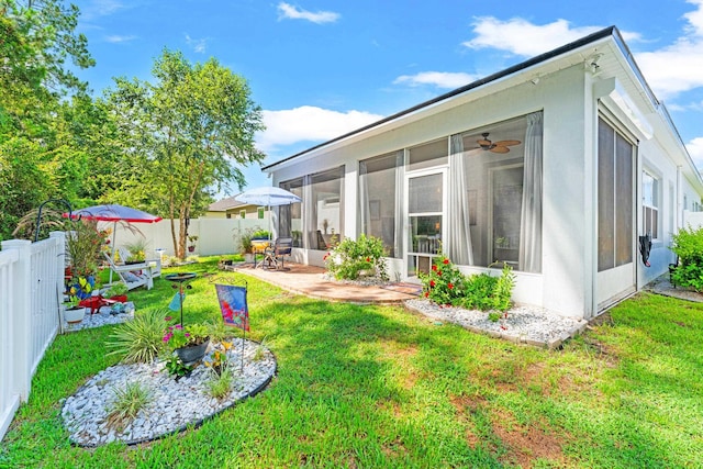 313 Aventurine Ave, Saint Augustine, FL 32086 - rear view of property featuring a sunroom, a fenced backyard, and a patio
