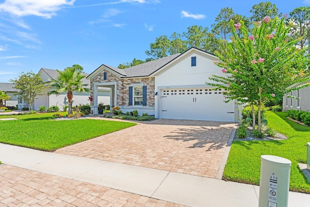 313 Aventurine Ave, Saint Augustine, FL 32086 - ranch-style home featuring a garage, a front yard, decorative driveway, and stone siding