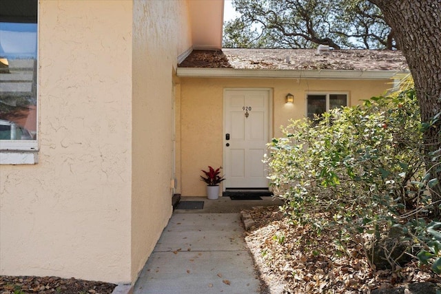 property entrance with stucco siding