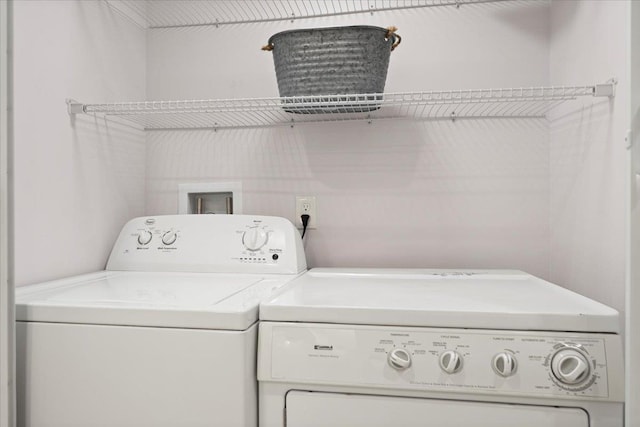 clothes washing area featuring washing machine and clothes dryer and laundry area