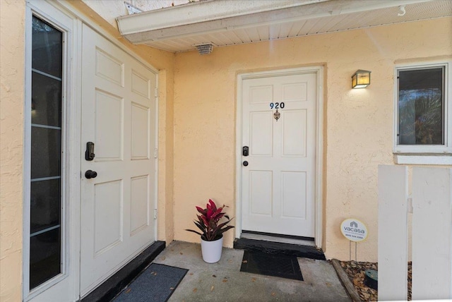 property entrance featuring stucco siding