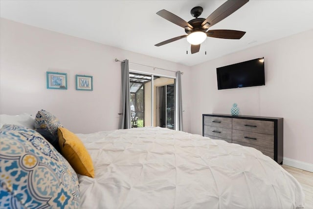 bedroom with wood finished floors, a ceiling fan, baseboards, and access to outside