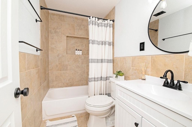 full bathroom with vanity, tile patterned floors, toilet, shower / bathtub combination with curtain, and tile walls