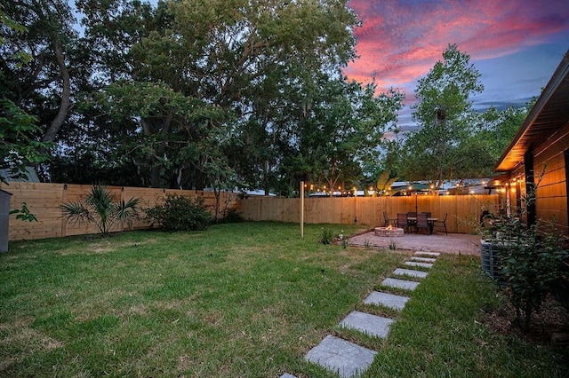 yard at dusk featuring a patio