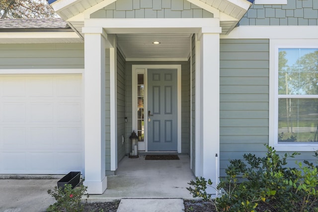 doorway to property with a garage