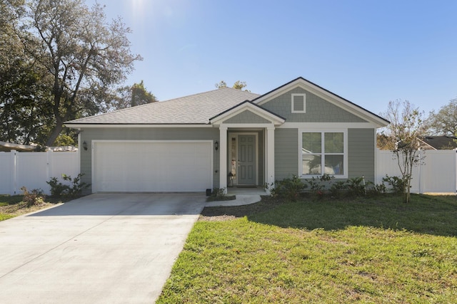 view of front of house with a garage and a front yard