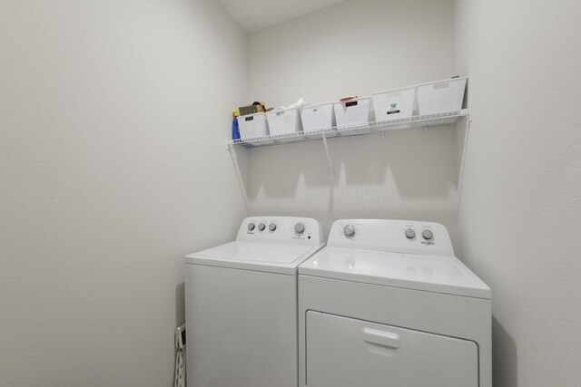 clothes washing area with washer and dryer