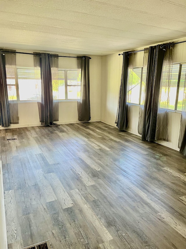 unfurnished room featuring hardwood / wood-style flooring