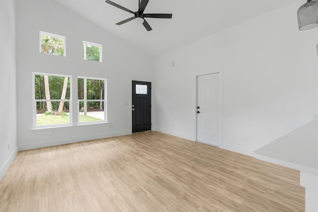 unfurnished living room featuring ceiling fan, light hardwood / wood-style flooring, and high vaulted ceiling