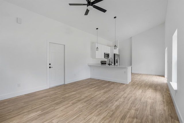 unfurnished living room featuring ceiling fan, high vaulted ceiling, and light hardwood / wood-style flooring