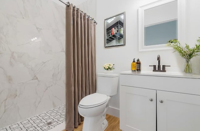 bathroom with a shower with shower curtain, wood-type flooring, vanity, and toilet