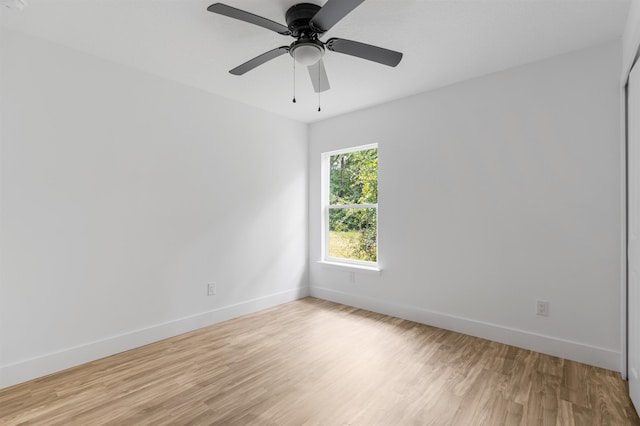 spare room with ceiling fan and light wood-type flooring