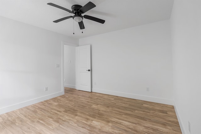 spare room with hardwood / wood-style flooring and ceiling fan