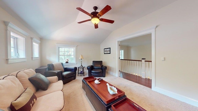 living room featuring ceiling fan, light colored carpet, and vaulted ceiling