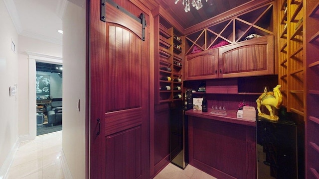 wine cellar featuring ornamental molding and light tile patterned floors