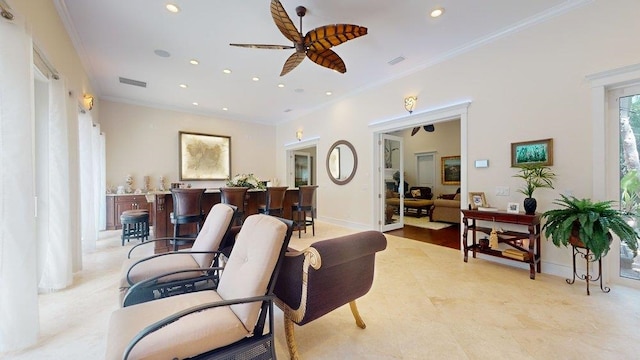 living room featuring ceiling fan and crown molding