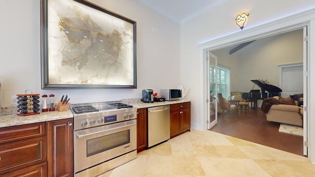 kitchen featuring light stone countertops, ornamental molding, vaulted ceiling, and appliances with stainless steel finishes