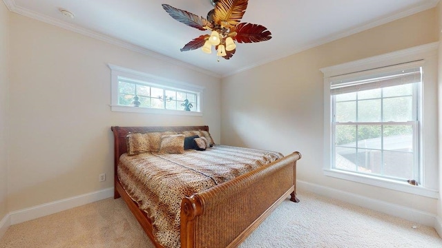 carpeted bedroom featuring ceiling fan and ornamental molding