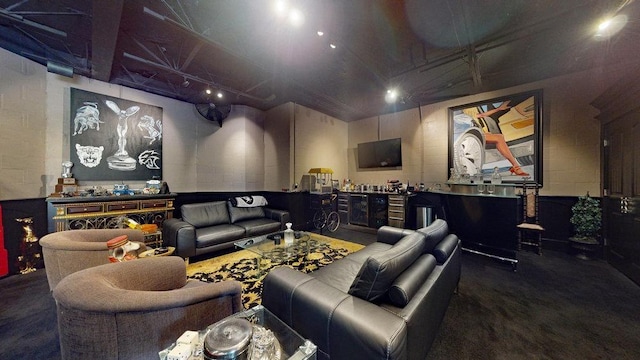 cinema room with concrete flooring and bar area