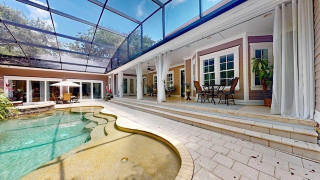 view of pool with a patio, ceiling fan, and a lanai